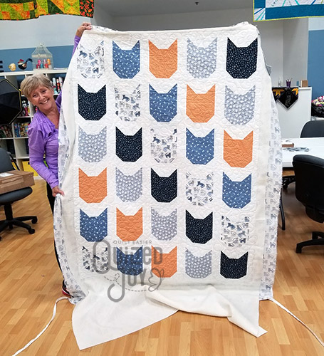 Cheri's cat quilt after longarm quilting it at Quilted Joy